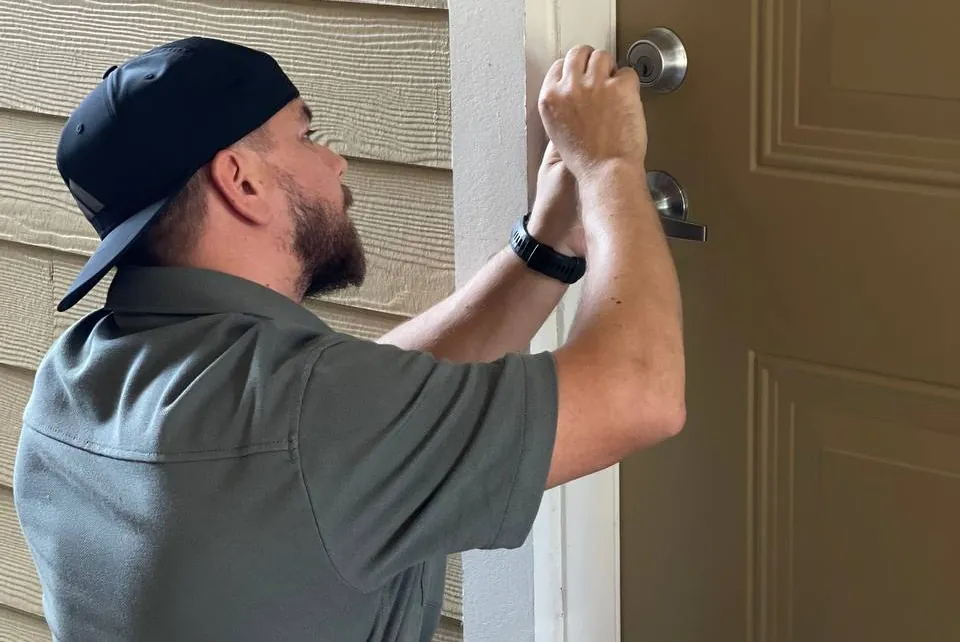 AK Locksmith technician working on a front door deadbolt