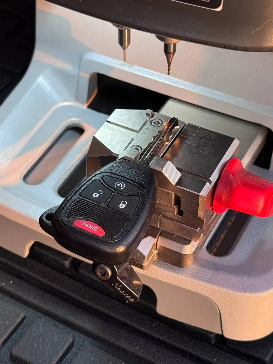 Jeep remote head key clamped in a key cutting machine